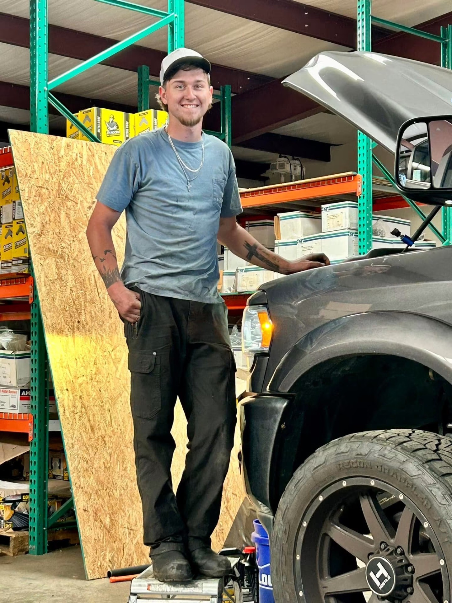 Gunnells technician in the parts warehouse next to a truck being serviced