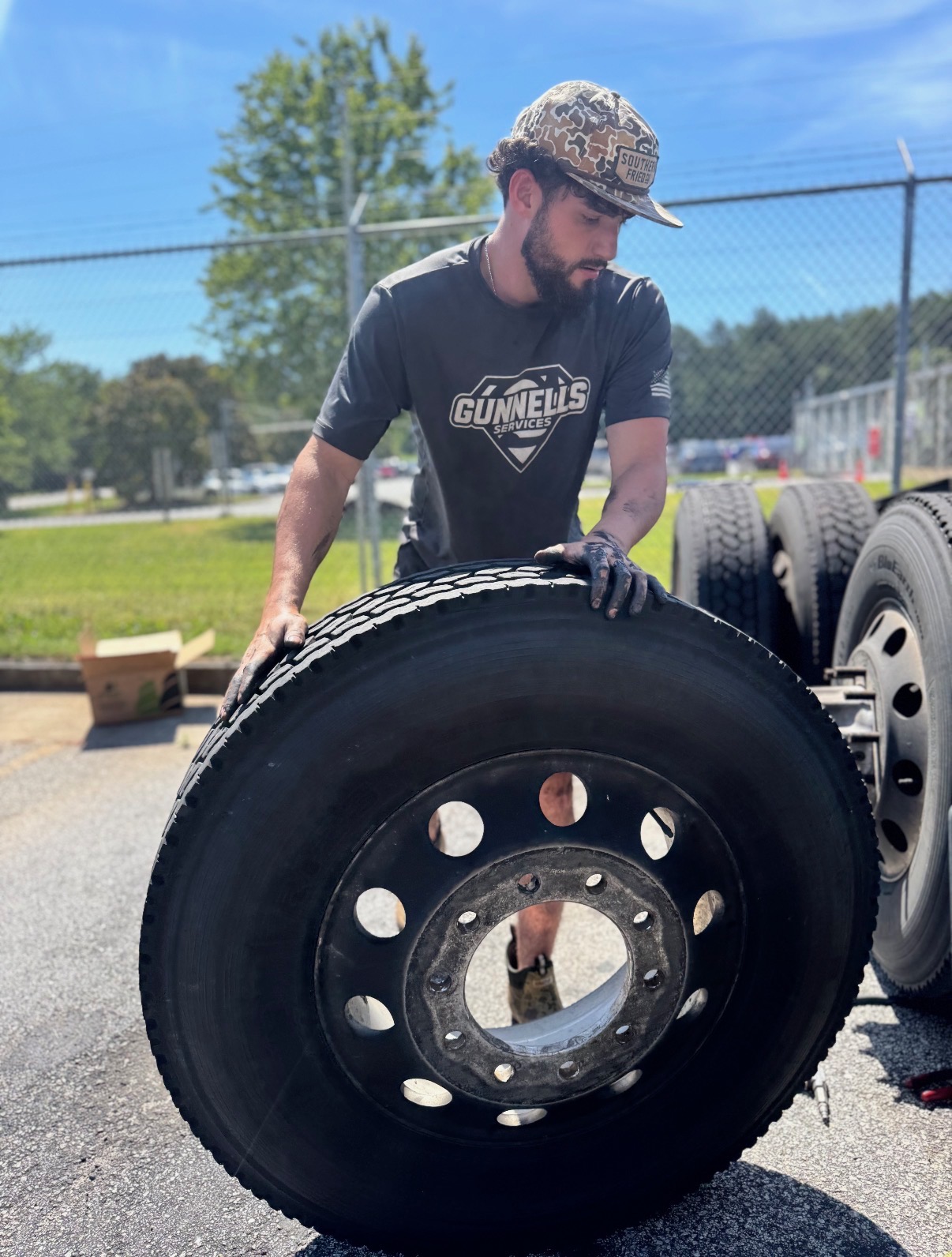 Gunnells tech mounting a commercial truck tire on a dual wheel
