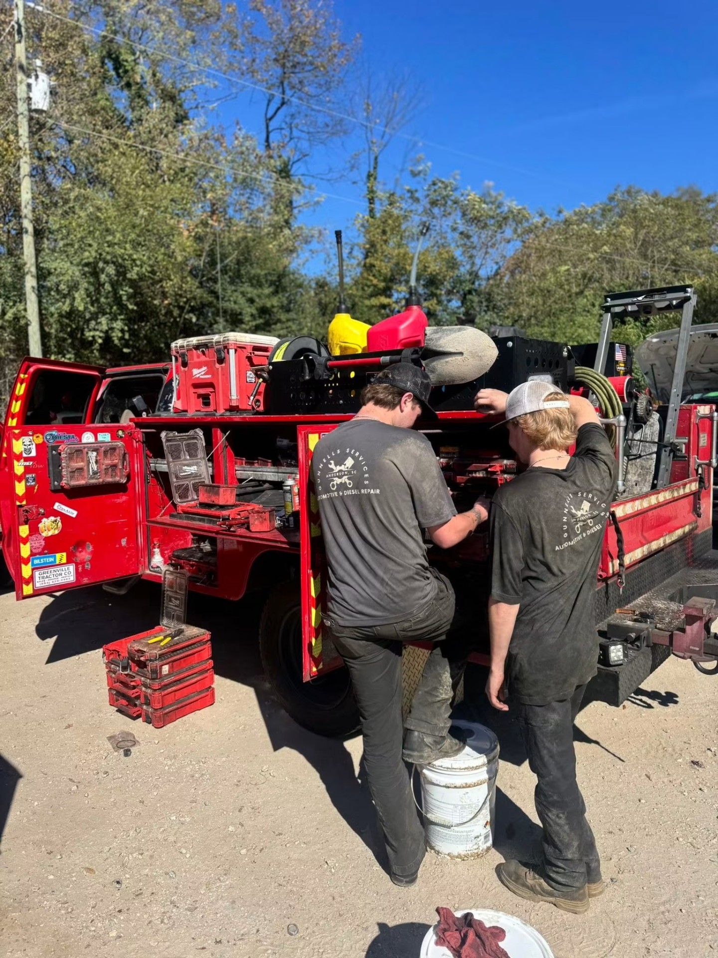 Two Gunnells Services techs in branded shirts working out of the mobile service truck