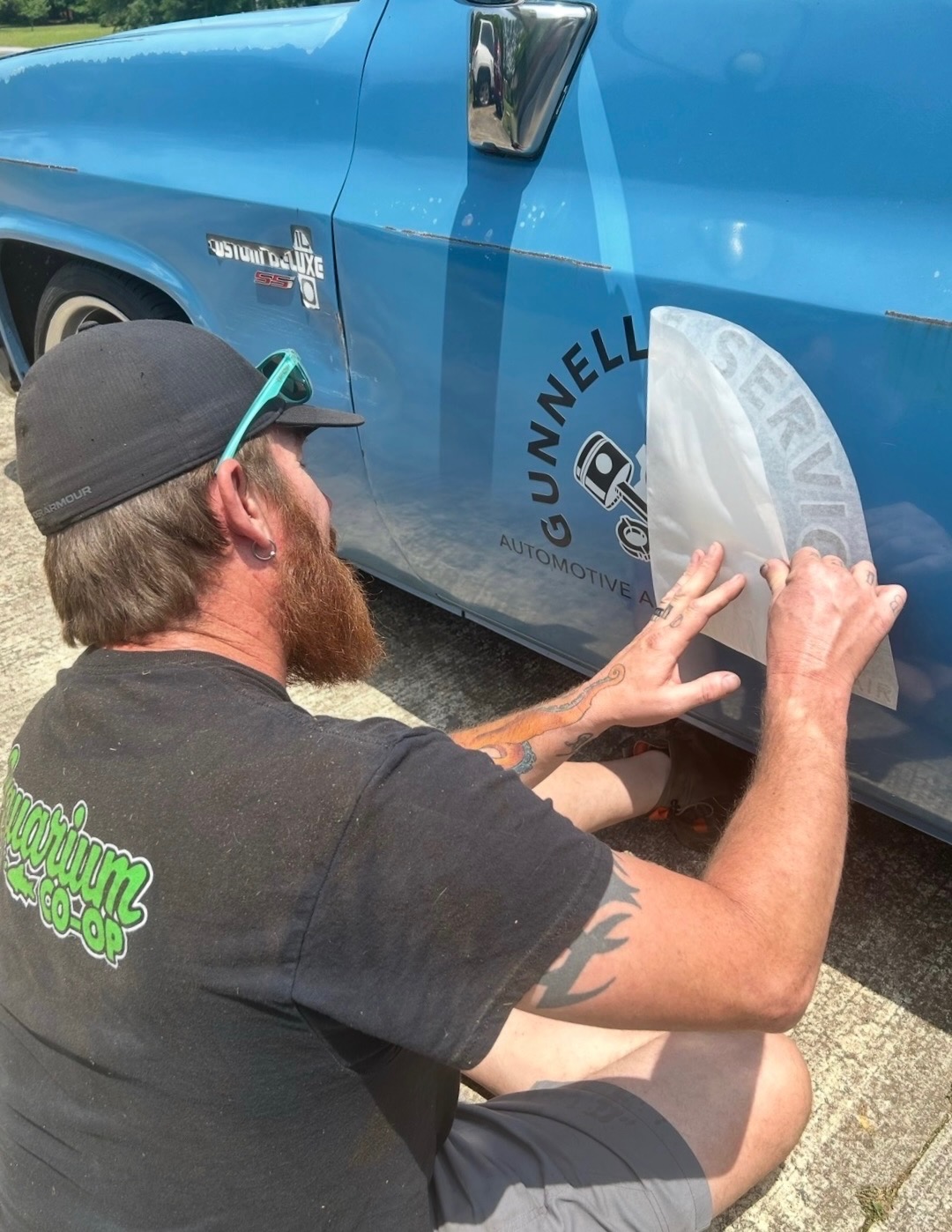 Michael applying the first Gunnells Services logo to his truck