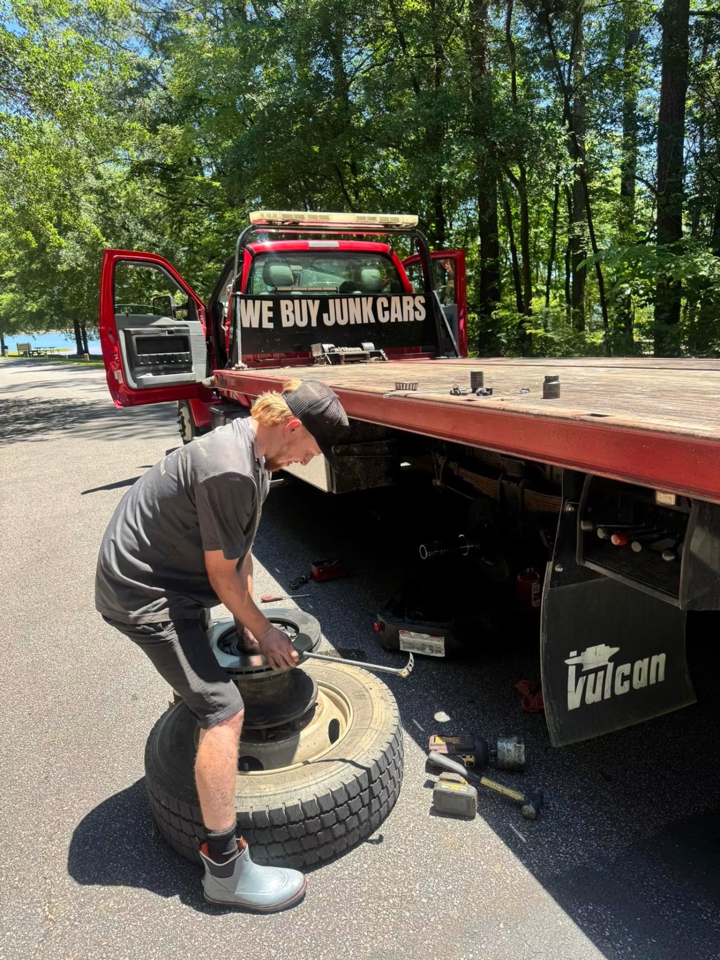 Gunnells tech on a mobile call repairing a Kubota skid steer in the woods
