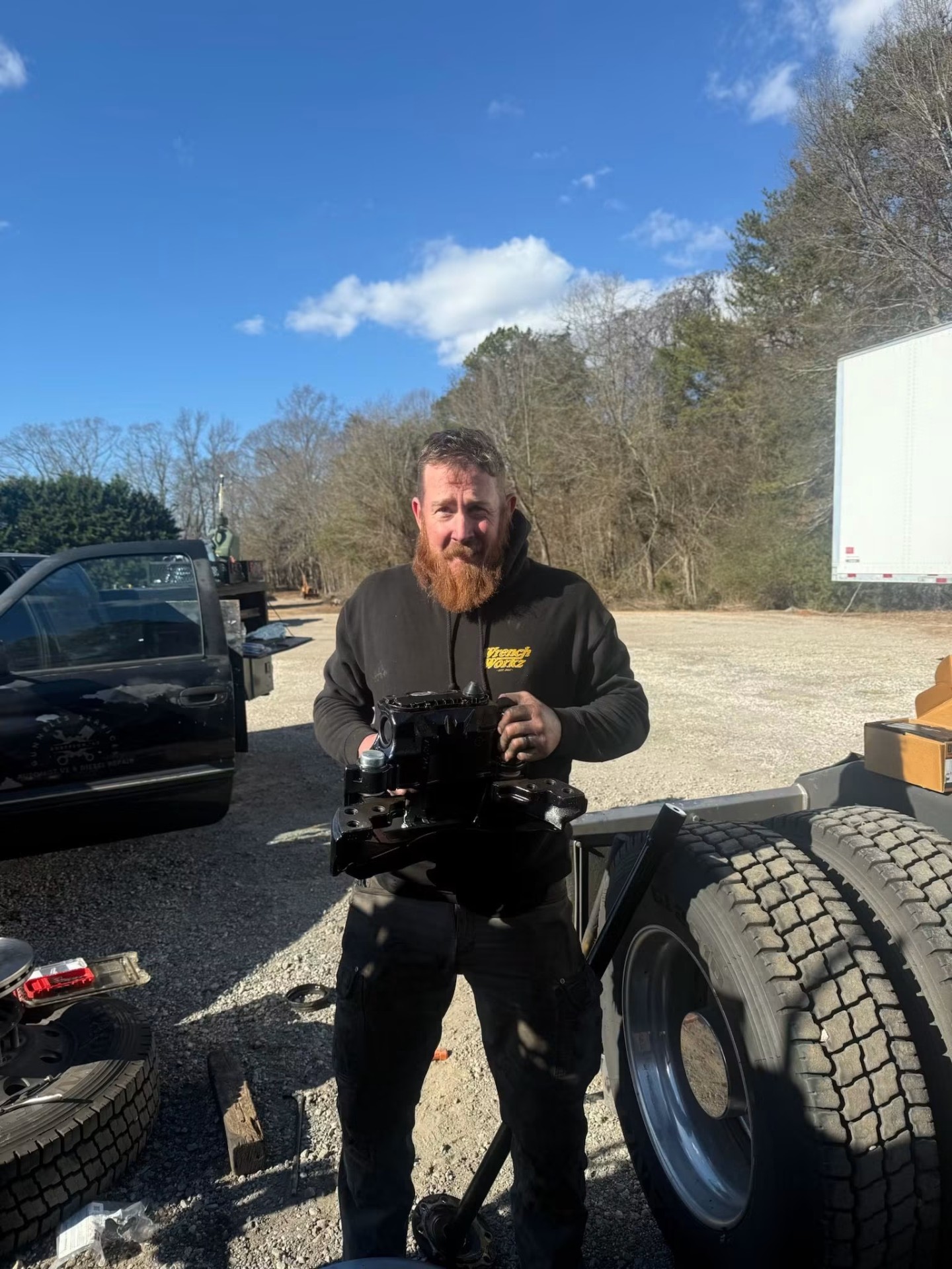 Gunnells technician holding a freshly rebuilt heavy-duty truck component