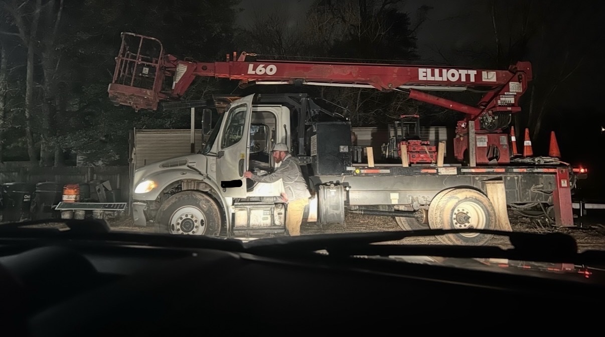 Michael beside a borrowed truck in the dark on an early service call